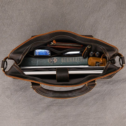 Interior of Heritage leather briefcase showing 15 inch laptop sleeve, book, and organizer pockets for professional tools.
