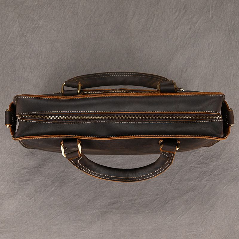 Top view of Heritage full-grain leather 15" laptop briefcase in dark brown with brass zipper and dual carry handles.