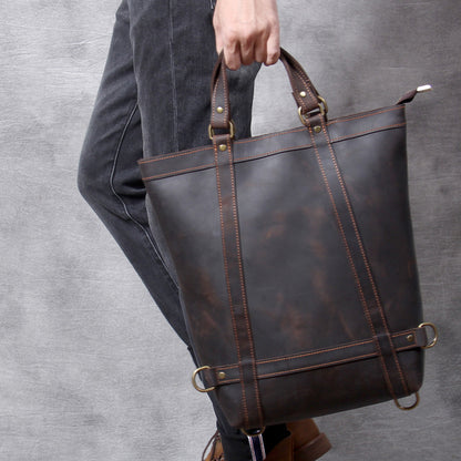 Full Grain Leather Backpack Tote 15in 3 Way Carry Laptop Bag Men held by a person, showcasing its dark brown color and design.