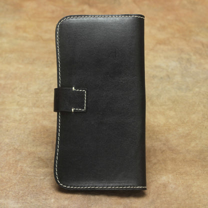 Full Grain Leather Long Wallet Hand Stitched Strap Clasp Clutch in elegant black color on textured background.