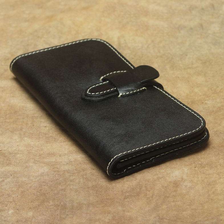 Full Grain Leather Long Wallet Hand Stitched Strap Clasp Clutch in black leather on a textured background.