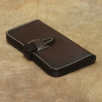 Full Grain Leather Long Wallet Hand Stitched Strap Clasp Clutch in dark brown leather on a textured background.
