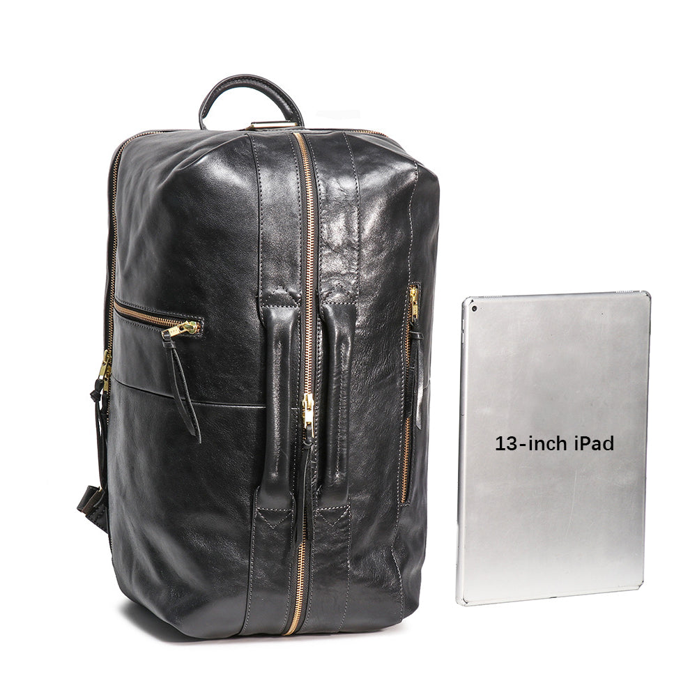 Executive 18-inch black full-grain leather laptop backpack with gold hardware next to a 13-inch iPad for scale.