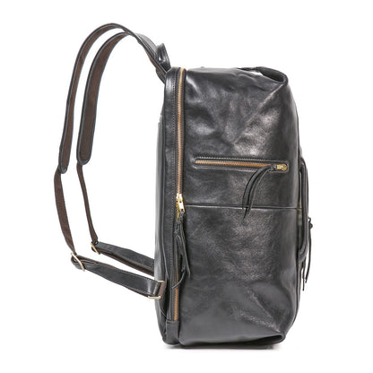 Side profile of an 18-inch executive black full-grain leather laptop backpack with gold zippers and padded straps.