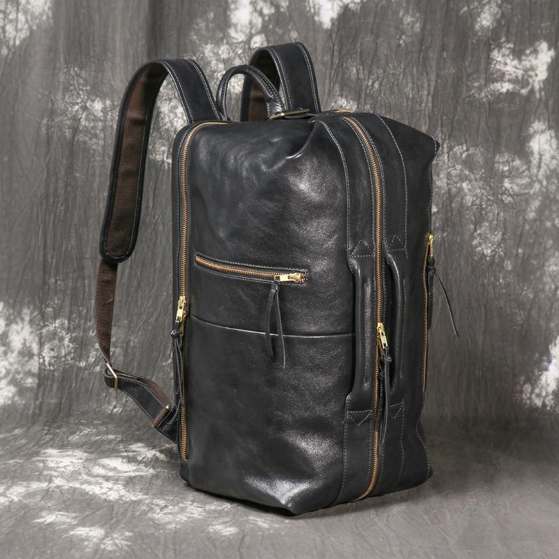 Executive 18-inch full-grain black leather laptop backpack for men featuring dual travel handles and gold zippers.