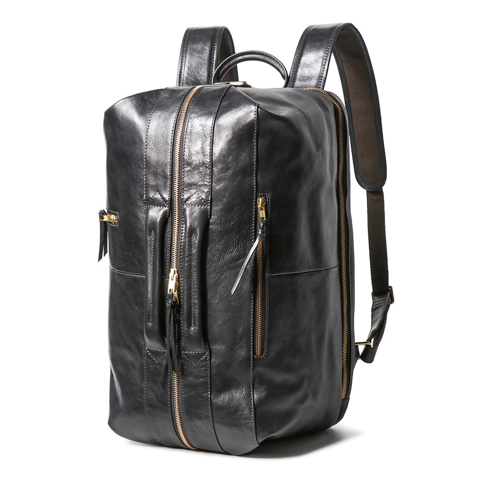 Executive 18-inch black full-grain leather laptop backpack with gold zippers and reinforced top and front handles.
