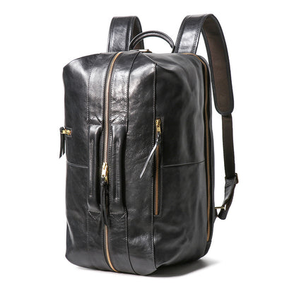 Executive 18-inch black full-grain leather laptop backpack with gold zippers and reinforced top and front handles.