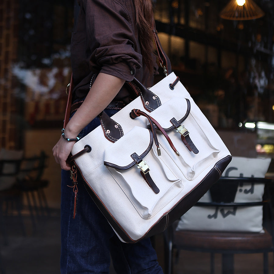 Large Canvas Leather Tote Bag being carried as a stylish crossbody shoulder bag with pockets.