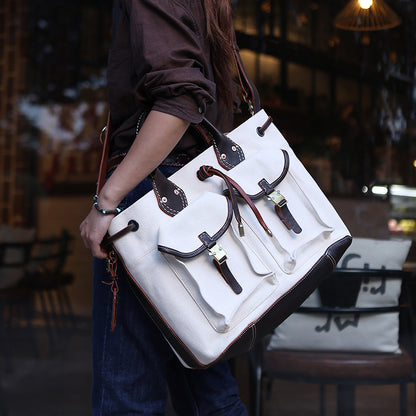 Large Canvas Leather Tote Bag being carried as a stylish crossbody shoulder bag with pockets.