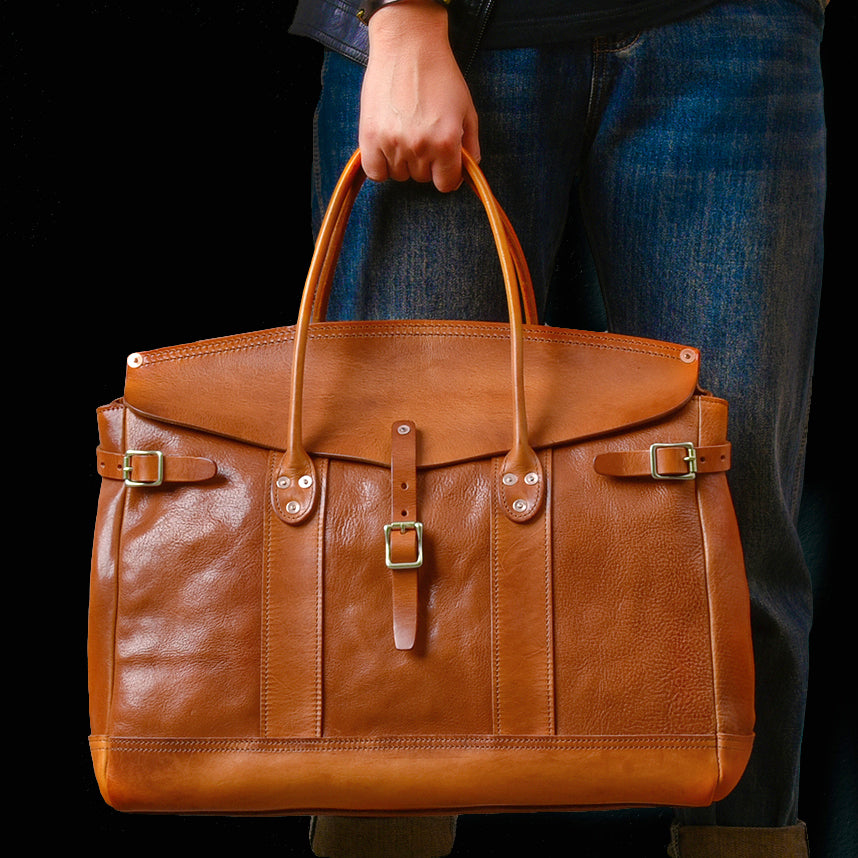 Italian Leather Travel Bag 17.7in Large Laptop Tote Weekender Briefcase in hand with a stylish brown finish.
