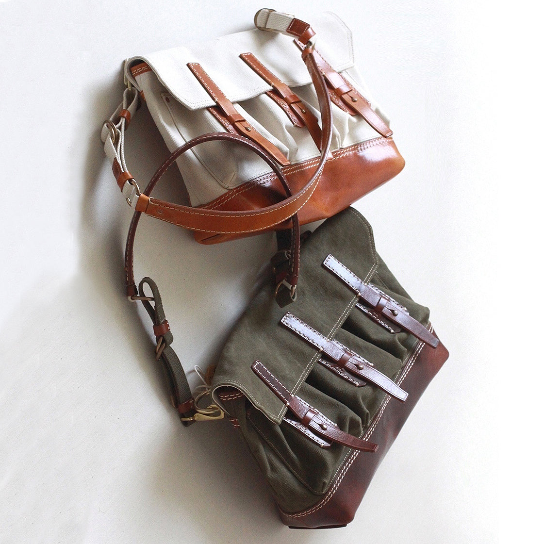 Canvas Leather Messenger Bag in three colors: beige, brown, and olive green stacked together.