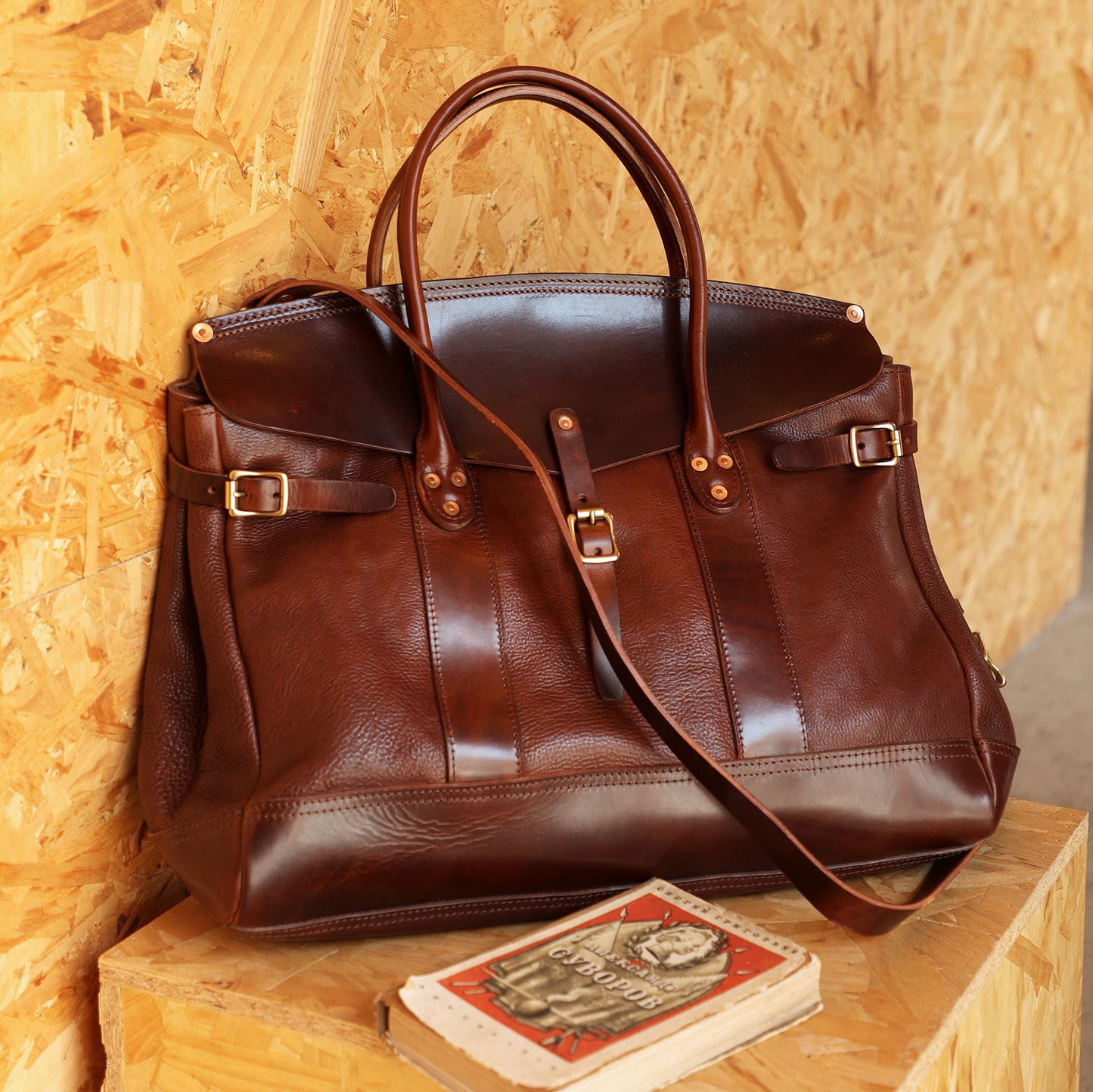 Italian Leather Travel Bag on a wooden surface, perfect for weekender and business needs.