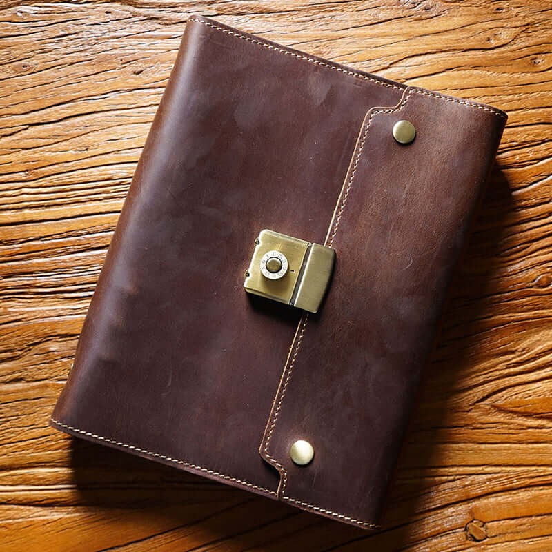 Refillable Leather Planner A5 With Lock Business Organizer 9in laying on a wooden table.