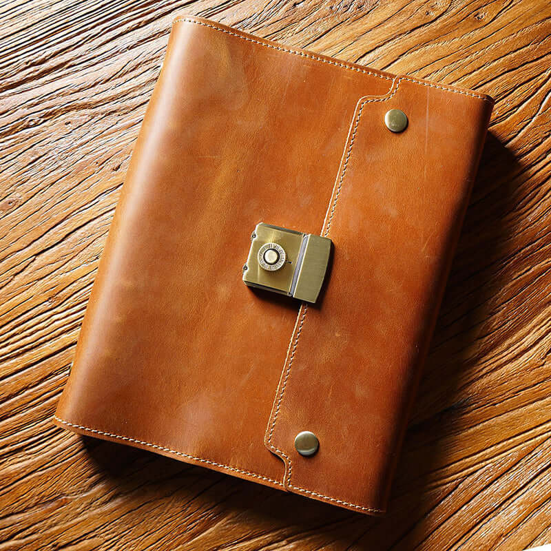 Refillable Leather Planner A5 With Lock Business Organizer 9in in tan leather with a lock on a wooden surface.