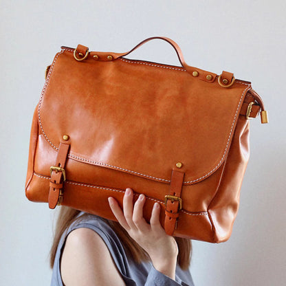 Leather Messenger Bag 13.8in Laptop Briefcase Crossbody Unisex held by a person showcasing its design.
