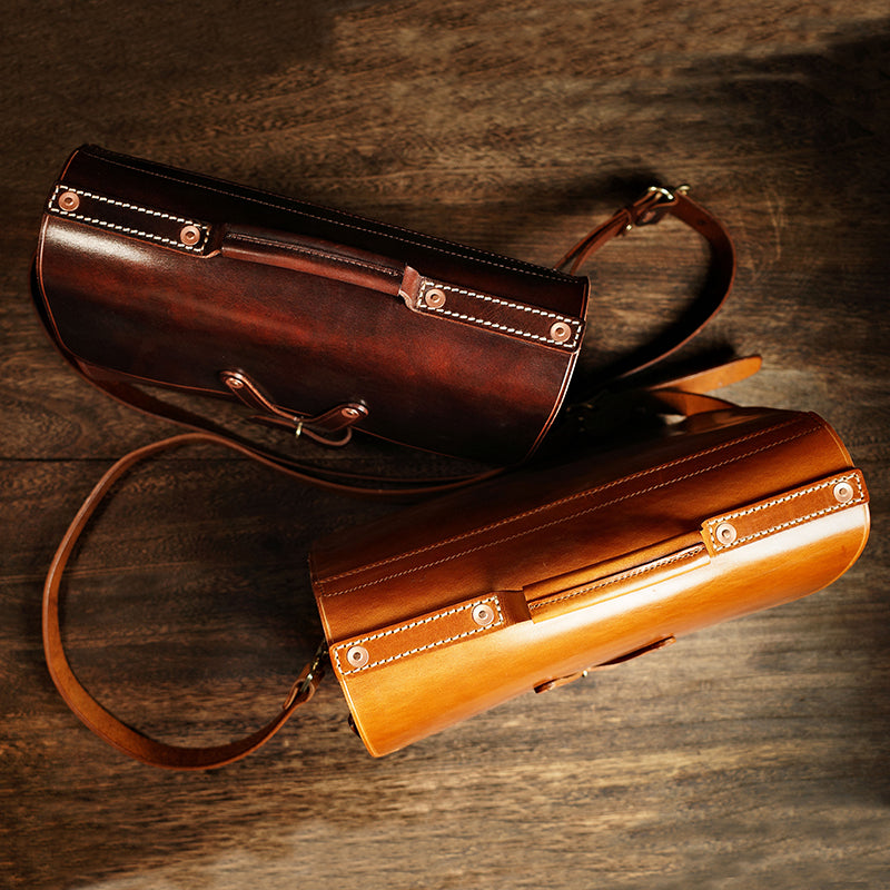 Handmade Italian Leather Laptop Bag Men in brown and tan colors displayed on a wooden surface.