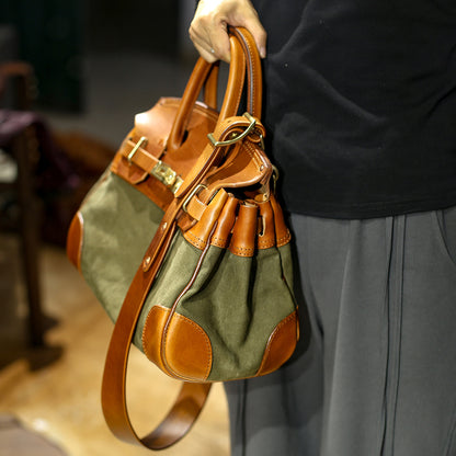 Leather Canvas Crossbody Bag held by a person, showcasing the blend of leather and canvas fabrics, perfect for women's fashion.