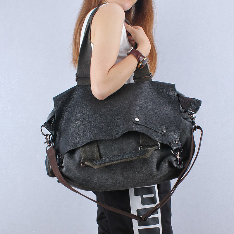 Woman carrying a large distressed leather weekend tote bag with top handles and adjustable straps.