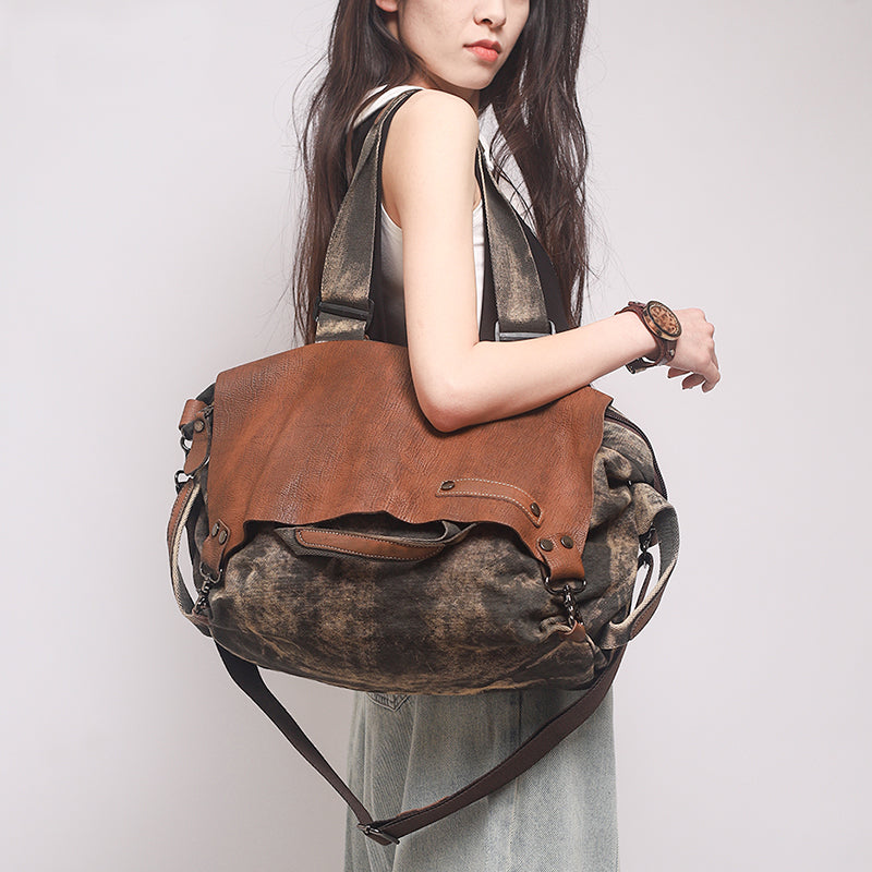 Woman holding a large soft leather canvas weekend bag, featuring a distressed top-grain leather flap, perfect for travel.