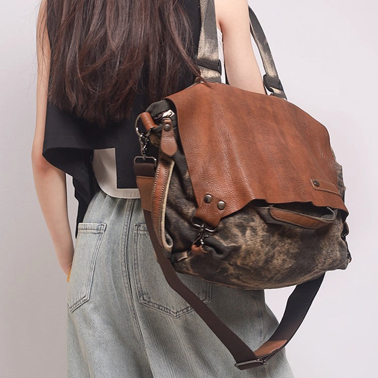 Woman carrying a stylish soft leather canvas weekend bag with distressed top-grain leather, perfect for travel.