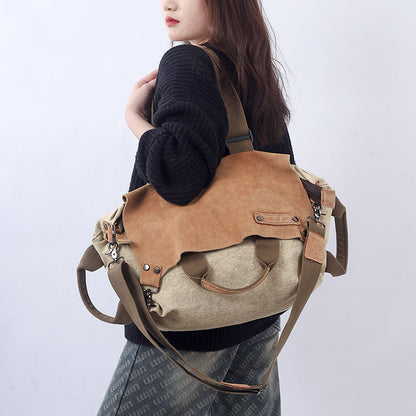 Woman holding a soft leather canvas weekend bag in a stylish design, perfect for travel and everyday use.