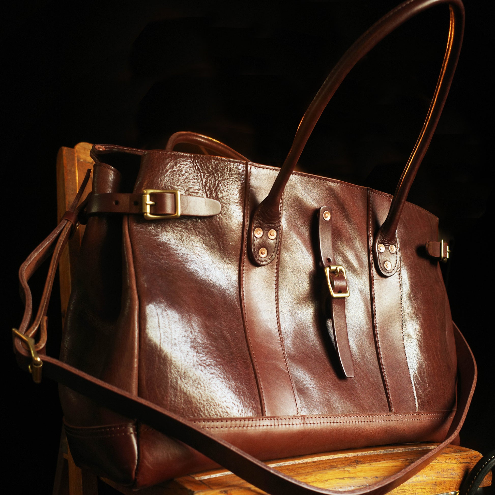 Italian Leather Travel Bag 17.7in Large Laptop Tote Weekender Briefcase in rich brown leather on a wooden surface.