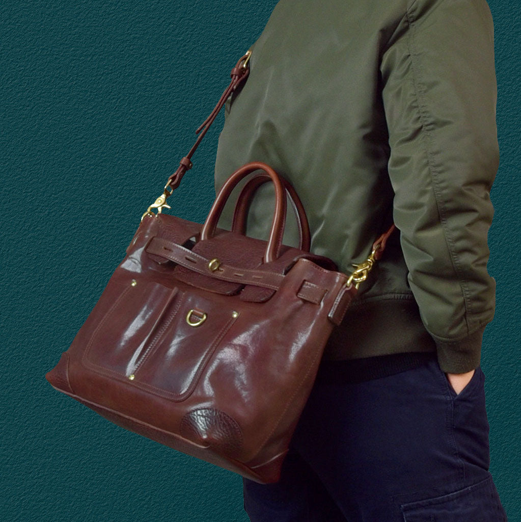 Vegetable-Tanned Leather Work Tote Laptop Briefcase Bag being carried by a person, showcasing its premium design and functionality.