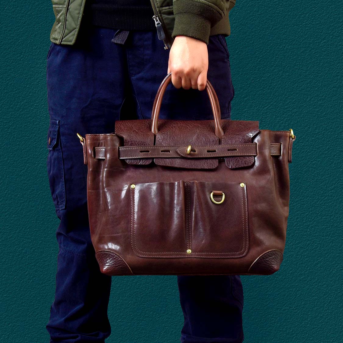 Vegetable-Tanned Leather Work Tote Laptop Briefcase Bag held by a person, showcasing its premium craftsmanship and stylish design.