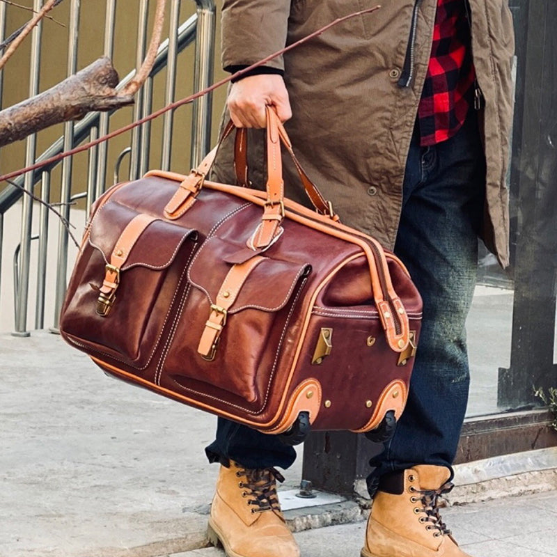 Leather Travel Bag With Wheels being carried by a person outdoors, showcasing its stylish design and durable material.