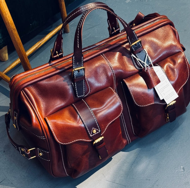 Handmade Leather Travel Bag With Wheels, 23.6in carry-on rolling duffel luggage, brown leather with front pockets.