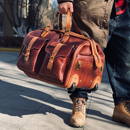 Leather Travel Bag With Wheels being carried by a person, showcasing its rich brown color and durable design.