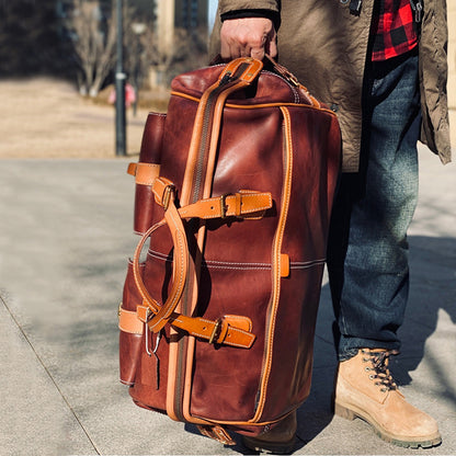 Handmade Leather Travel Bag With Wheels being carried, showcasing its durable design and stylish appearance.