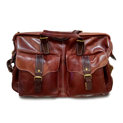 Handmade Leather Travel Bag With Wheels in brown, featuring front pockets and top handles for easy carrying.