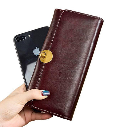 Leather Long Wallet Women Turn Lock Card Slots Phone Slot Purse in hand with smartphone.